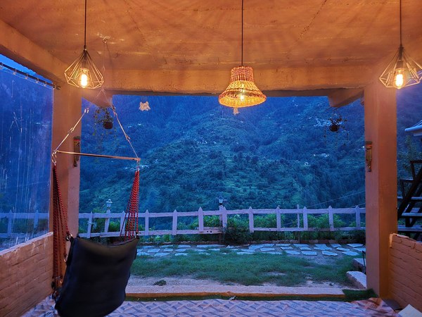 Covered sit-out with swing and lanterns